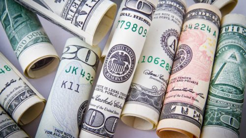 Rolled U.S. dollar bills used to describe illegal side hustles